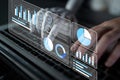 Futuristic interface with robotic hand interacting with data analytics display, showcasing graphs, charts, and Royalty Free Stock Photo