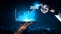 Futuristic Technology Concept Showing Robotic Hand Pointing at Growth Chart on Tablet with Year Indicators for 2023 to Royalty Free Stock Photo