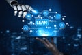 Futuristic Robot Hand Interacting with Digital Lean Management Infographic on a Tablet with Icons Representing Royalty Free Stock Photo