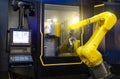 Robotic hand machine tool at industrial manufacture factory working in conjunction with a numerically controlled machine Royalty Free Stock Photo