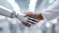 Robotic hand shakes with human hand in a biomedical engineering setting Royalty Free Stock Photo