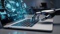 Robotic hand typing on a laptop keyboard with glowing blue AI interface and data visualizations on screen Royalty Free Stock Photo