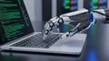 Robotic Hand Typing on a Laptop Keyboard with Green Code Displayed on the Screen artificial intelligence Royalty Free Stock Photo