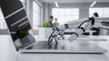 Robotic Hand Typing on a Laptop Keyboard in a Modern Office Environment with Blurred Colleagues Royalty Free Stock Photo