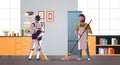 Robotic janitor with man cleaner sweeping and cleaning robot vs human standing together artificial intelligence