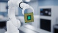 Robotic arm holding a computer processor chip in a cleanroom manufacturing environment Keywords: robot arm, robotic arm, Royalty Free Stock Photo