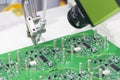 The robotic system for the soldering process with the electronics board. Royalty Free Stock Photo