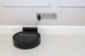 Robotic Vacuum Cleaner Charging Battery Smart Cleaning Technology. Modern smart electronic housekeeping technology