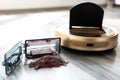 Robotic vacuum cleaner on wood floor with emptied dirt container