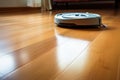 Robotic vacuum cleaner on laminate wood floor. Modern smart cleaning technology