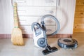 Robotic vacuum cleaner on laminate wood floor smart cleaning technology. Selective focus Royalty Free Stock Photo