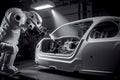 Robotic welder in automotive industry, white robot welding car body in car factory