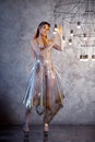 Robotic woman in a plastic dress, future fashion concept. Stylish young woman