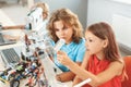Robotics. Children sitting having class making robots working on details concentrated pensive Royalty Free Stock Photo