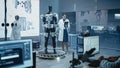 In Robotics Development Laboratory: Female Scientist Uses Digital Tablet Computer, Work on a Robot