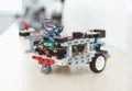 Robotics. Robot car on table isoalated close-up modern technology blurred