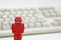 Robots or artificial intelligence and PC keyboard on white background. Royalty Free Stock Photo