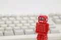 Robots or artificial intelligence and PC keyboard on white background. Royalty Free Stock Photo