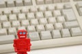 Robots or artificial intelligence and PC keyboard on white background. Royalty Free Stock Photo