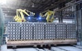 Robots manipulators stack bricks in a brick factory in a workshop
