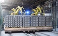 Robots manipulators stack bricks in a brick factory in a workshop