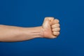 Robust man& x27;s hand isolated on a blue background showing a fist seen from the inside. Royalty Free Stock Photo