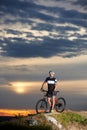 Robust and smiling cyclist posing near bike. Royalty Free Stock Photo