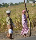 ROBY, ETHIOPIA - NOVEMBER 23, 2008: Two strangers Ethiopian women are on the road. Village in the background.