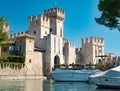 Rocca Scaligera, historical castle and old town on island, small harbor Royalty Free Stock Photo