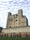 Rochester Castle surrounded by cumulus clouds in Kent, United Kingdom Royalty Free Stock Photo