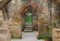 Rock archways leading out to a wrought iron gate