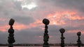 Rock balancing and cloudy dramatic sky on sunset. Stack of stones in balance. Royalty Free Stock Photo