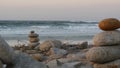 Rock balancing on pebble beach. Pyramid stacks of stones, ocean coast, sea water Royalty Free Stock Photo