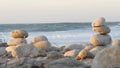 Rock balancing on pebble beach. Pyramid stacks of stones, ocean coast, sea water Royalty Free Stock Photo