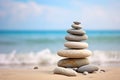 Rock balancing. Stones piled in balanced stacks in front of blurry beach background with copy space