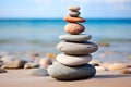 Rock balancing. Stones piled in balanced stacks in front of blurry beach background