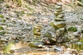 Rock balancing. Two piles of stacked rocks in a riverbed Royalty Free Stock Photo