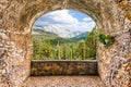 Rock balcony overlooking a beautiful green valley with forest