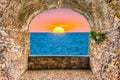 Rock balcony overlooking sunset by the mediterranean sea, Italy