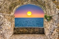 Rock balcony overlooking sunset by the mediterranean sea, Italy