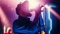 Rock Band Performing at a Concert in a Night Club. Portrait of a Lead Singer Singing into Micropho