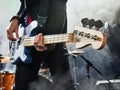 Rock band performs on stage. Bassist in the foreground. Royalty Free Stock Photo