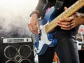 Rock band performs on stage. Bassist in the foreground. Royalty Free Stock Photo