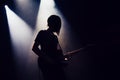 Rock band performs on stage. Guitarist plays solo. silhouette of guitar player in action on stage in front of concert crowd.