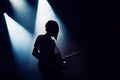 Rock band performs on stage. Guitarist plays solo. silhouette of guitar player in action on stage in front of concert crowd. Royalty Free Stock Photo