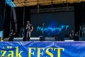 Rock band performs on a stage during outdoor free ethno-rock festival Kozak Fest