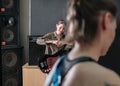 rock band rehearsal. studio audio check for a female band. professional musicians with guitars. smiling bass guitarist Royalty Free Stock Photo