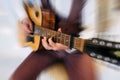 Rock band studio rehearsal. Male musician playing bass guitar before live concert with motion blur effect Royalty Free Stock Photo