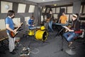 A rock band working in studio