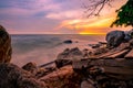 Rock beach with blue and golden sunset sky. Skyline between sea water and sky in the evening. Calm ocean with soft wave. Summer Royalty Free Stock Photo